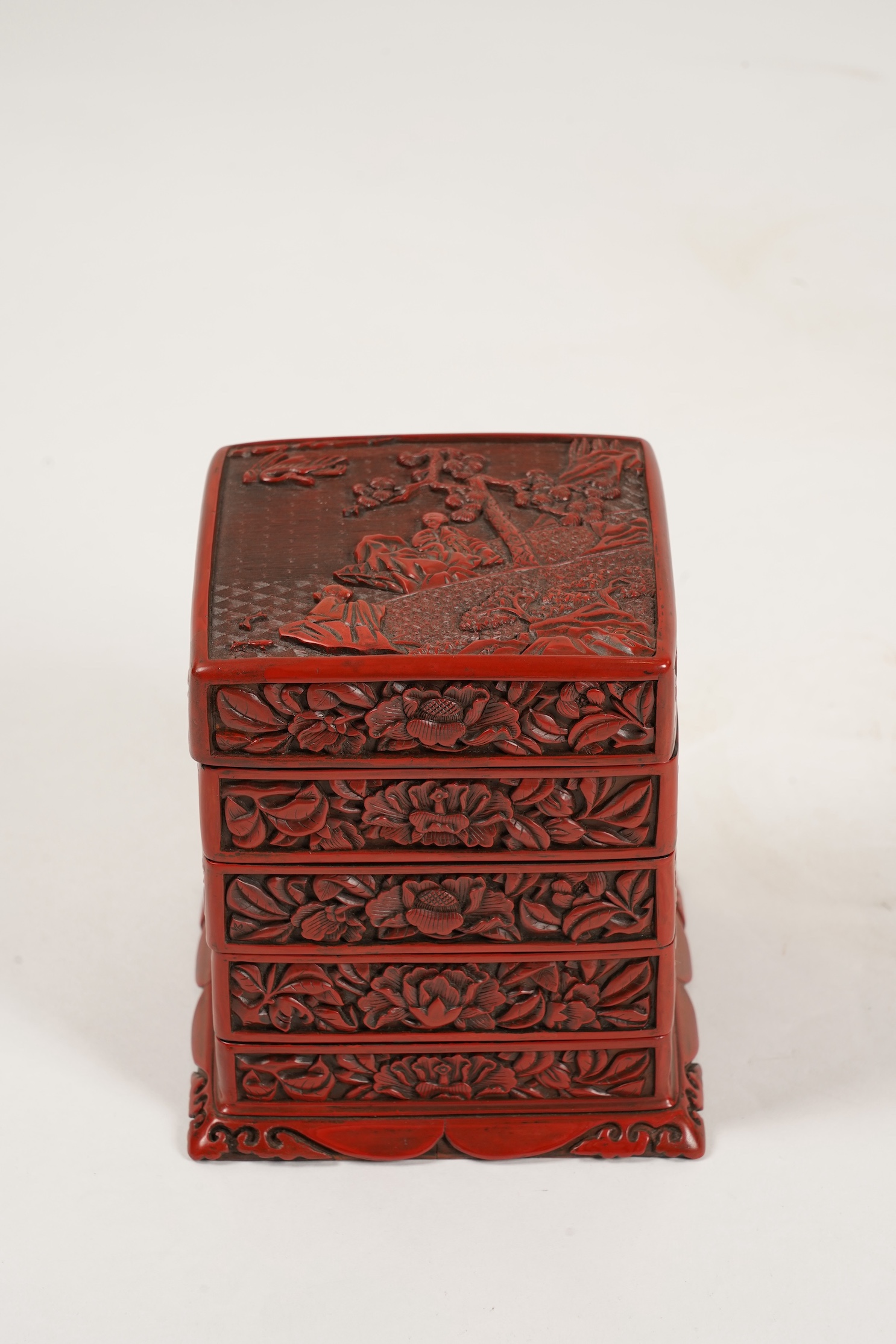 A Chinese Ming cinnabar lacquer four tier box, 15th century